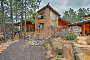 a log home with a stone walkway in front of it at Cabin on Rainbow Lake Views, Hot Tub and Dock in Pinetop-Lakeside