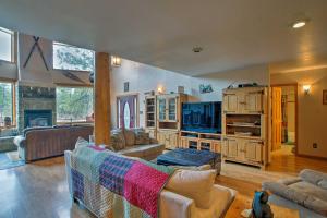 a living room with a couch and a table at Cabin on Rainbow Lake Views, Hot Tub and Dock in Pinetop-Lakeside