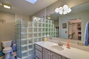 a bathroom with a sink and a toilet and a mirror at Cabin on Rainbow Lake Views, Hot Tub and Dock in Pinetop-Lakeside +23 photos