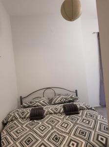 a bed with two pillows on it in a bedroom at Central City Kristalli studio in Thessaloniki