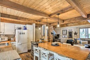 a kitchen and living room with wooden ceilings at Mountain Chalet with Hot Tub by Cle Elum Lake! in Cle Elum