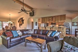 a living room with a leather couch and a table at High Gravity Banner Elk Custom Chalet with Views! in Banner Elk