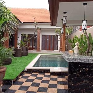 a swimming pool in front of a house at D&D homestay in Pesanggaran