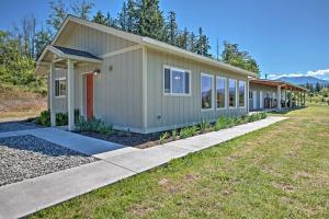 a tiny house with a red door in a yard at Sequim Cottage with Panoramic Olympic Mtn Views! in Sequim