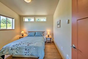 a bedroom with a bed and two windows at Sequim Cottage with Panoramic Olympic Mtn Views! in Sequim