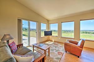 a living room with a couch and a table at Sequim Cottage with Panoramic Olympic Mtn Views! in Sequim