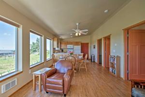 a living room with a ceiling fan and a table and chairs at Sequim Cottage with Panoramic Olympic Mtn Views! in Sequim