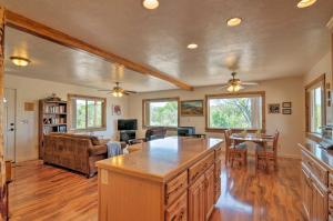 a kitchen with a large island in a living room at Cozy Henrieville Cabin 18 Mi to Bryce Canyon NP! in Henrieville