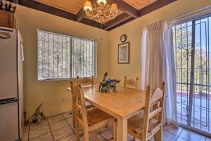 a dining room with a table and a refrigerator at Unique Cabin with Mtn Views-Steps to the Jemez River! in Jemez Springs