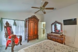 a bedroom with a bed and a mirror and a fan at Bright Spring Hill Home 5 Mi to Weeki Wachee Park in Spring Hill