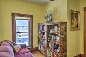 a living room with a book shelf filled with books at Historic Backus Home, Steps to Pine Mountain Lake! in Oshawa