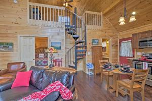 a living room with a spiral staircase in a log cabin at Hot Tub and Views Charming Bryson City Cabin! in Bryson City
