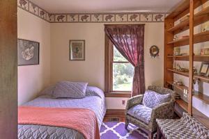 a bedroom with a bed and a chair and a window at Spacious Finger Lakes Vacation Rental on 6 Acres! in Naples