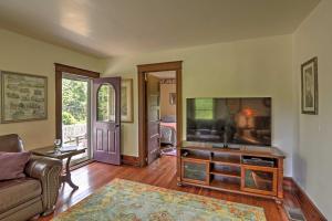a living room with a television and a couch at Spacious Finger Lakes Vacation Rental on 6 Acres! in Naples