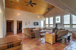 a living room with furniture and a ceiling fan at Traditional Taos Home 26 Acres with Mountain Views in Taos