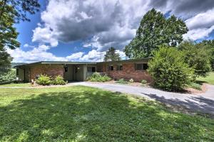 a brick house with a driveway in a yard at Stair-Free Lexington Home with Blue Ridge Mtn Views! in Lexington