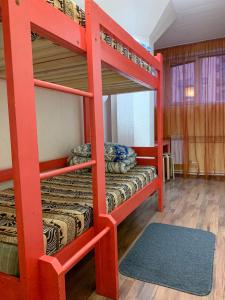a bunk bed room with two bunk beds and a rug at Vyborghostel in Vyborg