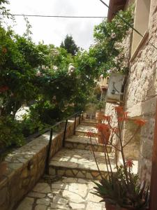 a set of stairs with plants and flowers at Cozy stone house in Sikéa +4 photos