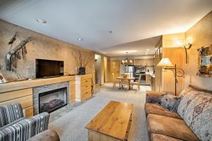 a living room with a couch and a fireplace at Big Sky Condo with Mountain Views, Hike, Ski and Fish! in Big Sky