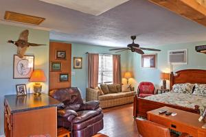 a living room with a bed and a couch at Paradise Cove Cabin with Boathouse and Dock in Guntersville