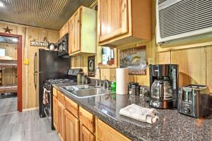 a kitchen with a sink and a counter top at Kentucky Cabin with 2 Fishing Ponds and Trail Access in New Concord +18 photos