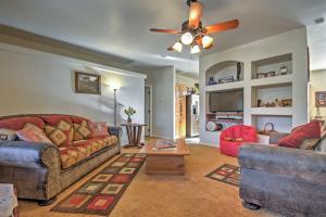 a living room with two couches and a ceiling fan at Beautiful Kanab Home with Yard - Walk to Restaurants in Kanab