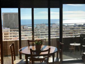 a table and chairs on a balcony with a view of a city at Apartamento with Jacuzzi & sea view in Alicante