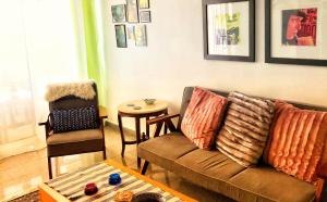 a living room with a couch and a chair at Iason Seaview home in Latchi in Polis Chrysochous +24 photos