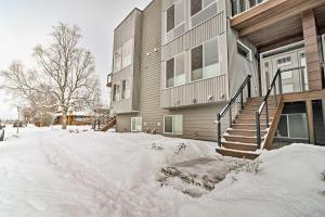 a house with snow on the ground in front of it at Modern Anchorage Townhome - By Delaney Park Strip! in Anchorage