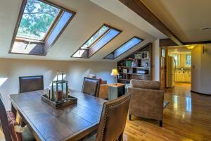 a dining room with a wooden table and skylights at Wooded Retreat with Deck 4 Mi to Downtown Flagstaff in Flagstaff