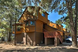 a house with a balcony on the side of it at Wooded Retreat with Deck 4 Mi to Downtown Flagstaff in Flagstaff
