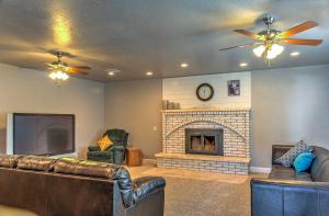 a living room with two couches and a fireplace at Central Escalante Home about 5 Mi to Grand Staircase! in Escalante