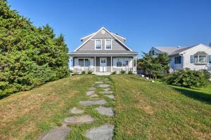a house with a stone path in the yard at Luxe Waterfront East Quogue Home with Beach On-Site! in East Quogue