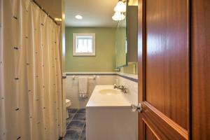 a bathroom with a sink and a toilet at Luxe Waterfront East Quogue Home with Beach On-Site! in East Quogue