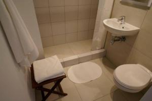 a small bathroom with a toilet and a sink at Pańska : city centre . Air conditioning . in Warsaw