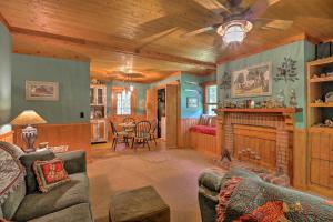 a living room with a couch and a fireplace at Cozy Pine Mountain Cabin with Screened Porch and Yard! in Pine Mountain