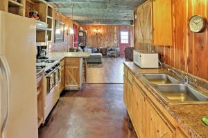 a kitchen with wooden cabinets and a counter top at Secluded Everton Retreat with Ozark Mountain Views! in Everton