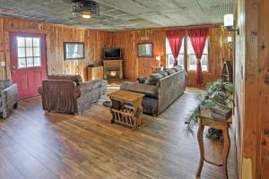 a living room with couches and a fireplace at Secluded Everton Retreat with Ozark Mountain Views! in Everton