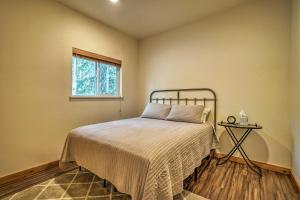 a bedroom with a bed and a window at Fishermans Cabin in Soldotna Near Kenai River! in Soldotna