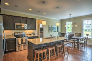 a kitchen with a large island and a dining room at Spacious Family-Friendly Retreat with Winter Rates! in Greensboro