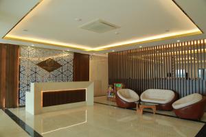 a lobby with two chairs and a tv in a room at Gold Boutique Hotel Danang in Da Nang