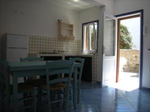 a kitchen with a table and chairs and a window at Residence Timeo in Ustica