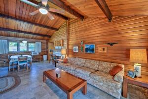 a living room with a couch and a table at Waterfront Manson Cabin on Lake Chelan with Deck! in Manson