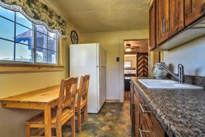 a kitchen with a wooden table and a white refrigerator at Hiawatha Peaceful Living in Rocky Mtn Natl Park in Allenspark