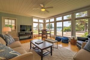 a living room with a couch and a table at Boutique Home in Door County with Eagle Harbor Views! in Ephraim