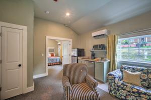 a living room with a couch and a chair at Downtown Branson Cottage with Pool Access! in Branson