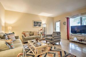 a living room with a couch and a tv at Ft Lauderdale Apt with Pool - 1 Mi to Beach Access! in Fort Lauderdale