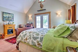 a bedroom with a bed and a fireplace at Waterfront Great Pond Cottage with Hot Tub and Deck! in Aurora