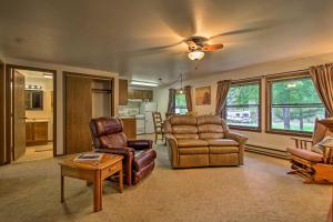 a living room with a couch chairs and a table at Cozy Anglers Apt - Steps to Trout Fishing River! in Columbus