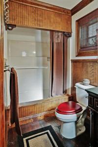 a bathroom with a toilet and a bath tub at Waterfront Astor Studio Cabin with Private Boat Dock in Astor